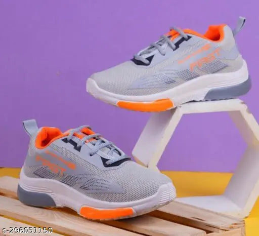 Grey sports shoes with orange and black accents, suitable for walking on hard surfaces