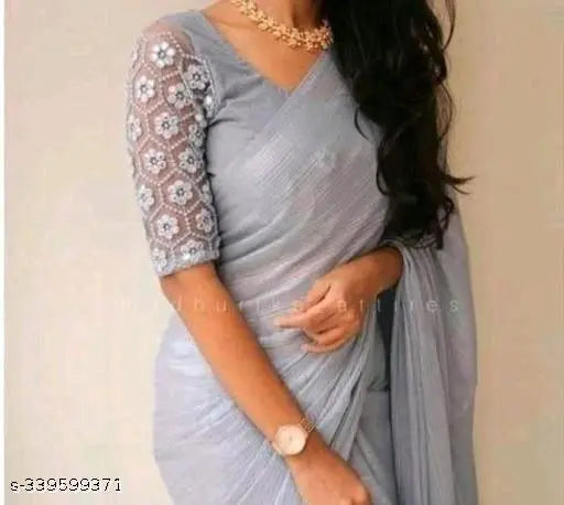 Shimmer grey Georgette saree with striped and embroidered net blouse, traditional Indian women's attire on display