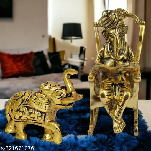 Golden Ganpati figurine with a Vedas book, elephant figurine, on a blue velvet carpet