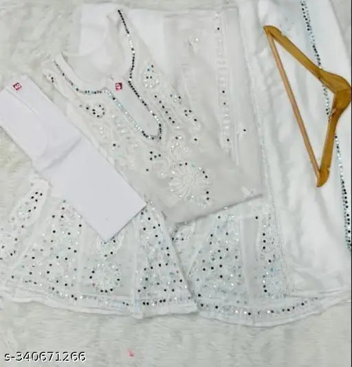 Women's fashionable ethnic wear. Lucknowi mirror work saree set in white chikankari fabric. Includes choli, pallu, blouse with matching inner and sharara, dupatta