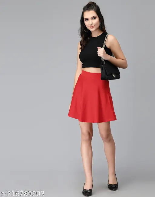 Red solid polyester A-line skirt, perfect for western-wear and parties. Full elasticated waistband with Aline hem. Size 28, 32 inches. Made in India