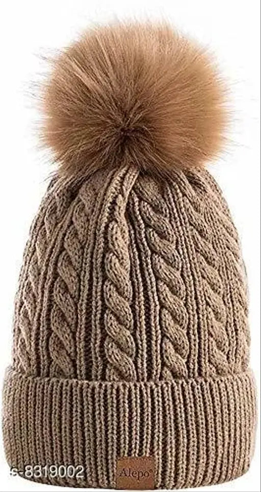 A women's beanie hat in brown fleece, featuring a large pompom on top and thick slouchy knitting. Warm lining for added comfort