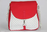 Red and white polka dot sling bag with a red strap