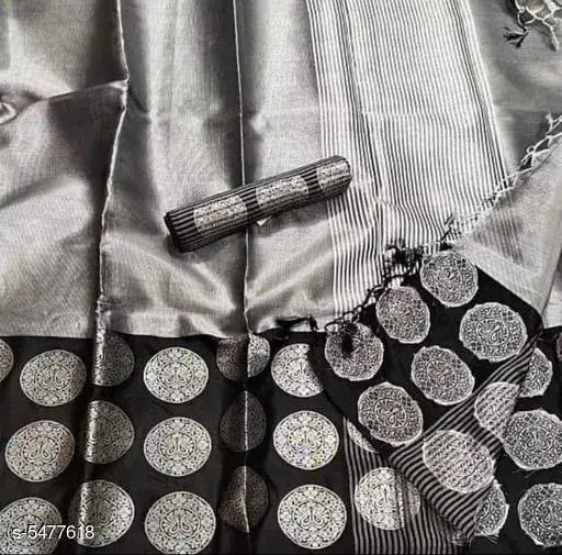 This is a close-up of an attractive Banarasi silk sari. The sari features intricate silver embroidery on a black background, giving it an elegant and luxurious look. The sari appears to be tied in the traditional pallu style, with one end draped over the shoulder and the other end hanging down freely