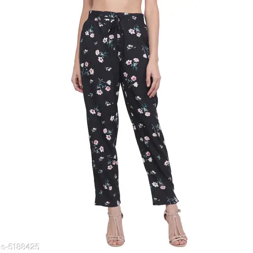 Black printed pyjama pants with floral pattern, mid-thigh length, elastic waistband