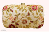 Floral pattern embroidered on a light background, gold embellishments, fabric clutch