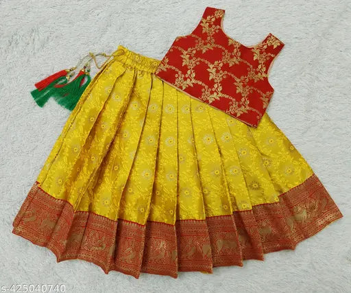 Red and green traditional baby girl's pattu pavadai lehenga choli, handcrafted from best quality Jacquard silk material. Elegant and graceful design for special occasions