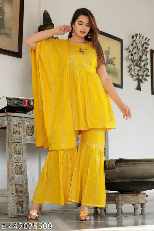 A person wearing a yellow kameez with ruffle sleeves and a matching dupatta