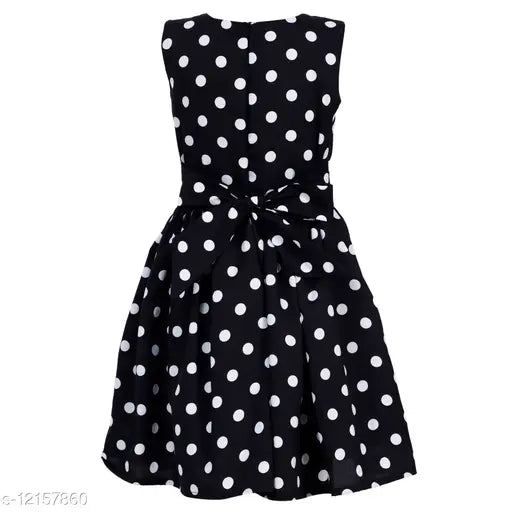 Black and white polka dot dress with bow tie waist, sleeveless, knee-length