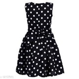 Black and white polka dot dress with bow tie waist, sleeveless, knee-length