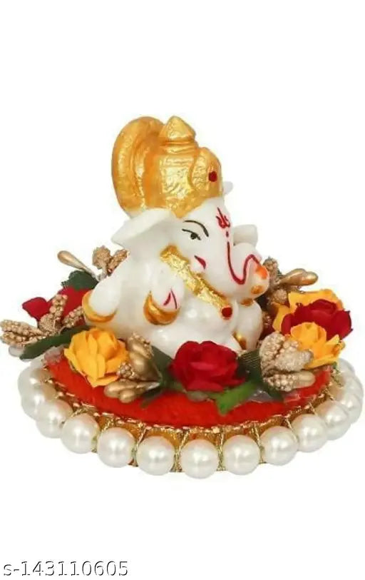 Multicolor polyresin Ganesha idol sitting on gungroo bangles decorated by flowers, 9 cm tall and hand-painted for a vibrant, peaceful decor piece