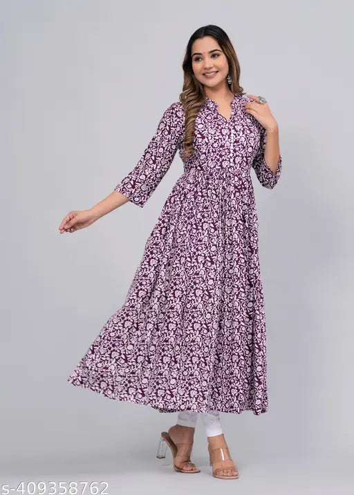 The image displays a woman wearing a long-sleeved, patterned kameez. It features a high neckline and is paired with a matching dupatta. The set includes a short kurta with a similar design