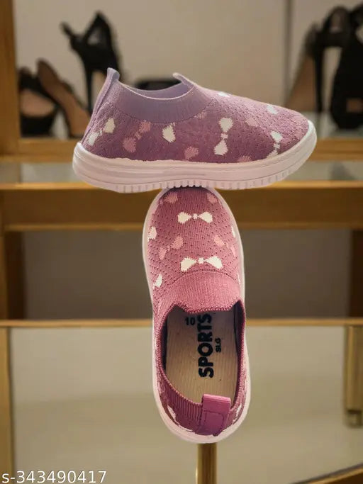 Children's casual sports shoes in purple with white dots and polka dot laces. Suitable for park walks, slip-ons, wearable for all day sports activities