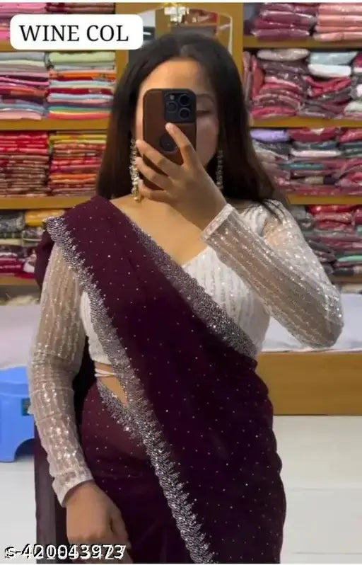 A woman in a traditional saree, showcasing its color and embroidery