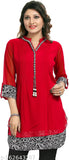 A woman in a red, solid, knee-length kurta with white embroidery on the neckline