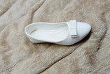 White fabric shoe with a bow on top