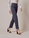 Dark grey formal trousers with a pointed toe and black strappy heels