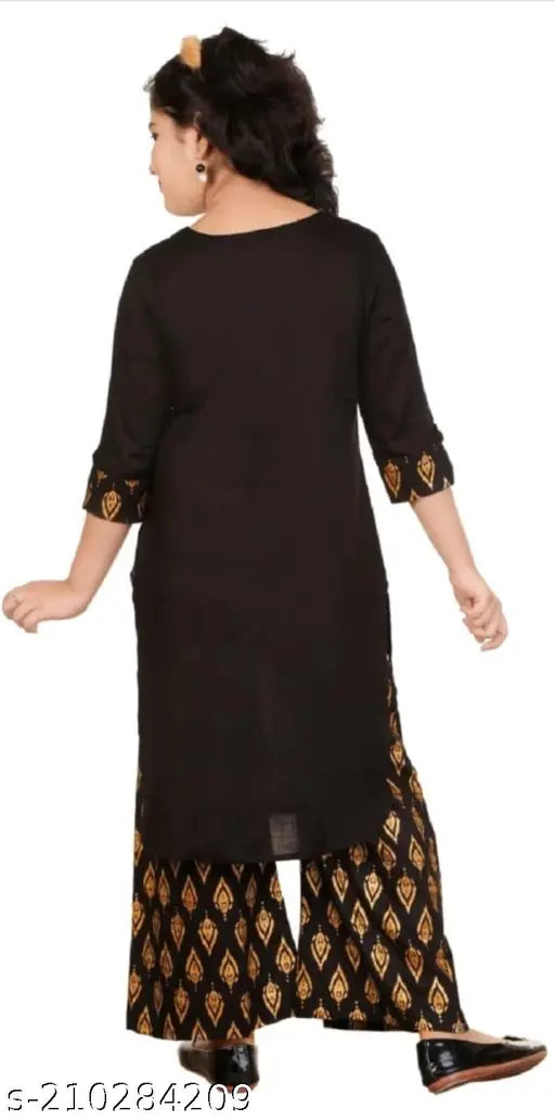 Rayon kids red kurta palazzo set, printed stylish kurta for girls in various sizes, 3-4 years to 12-13 years. Indian traditional clothing on model, printed patterns and three-quarter sleeves