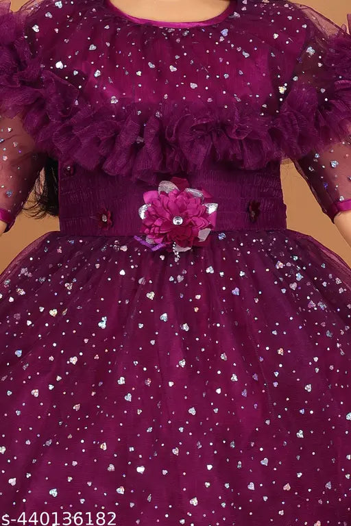 Purple glittery dress with ruffled sleeves, lace embellishments, and a floral brooch at waist