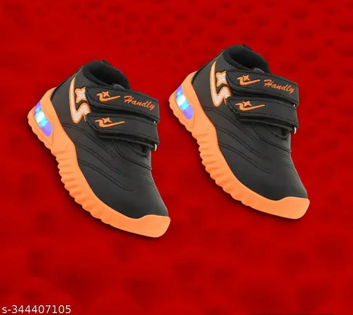 Orange and black kids' athletic shoes with Velcro straps, suitable for outdoor sports