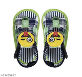 The image features a pair of colorful children's sandals with blue, white, and red colors. Each sandal has a large emoji face on the side, which appears to be a sad or crying face. The design includes black straps that wrap around the ankles