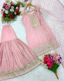 The image displays a set of women's clothing, specifically a long-sleeved top and a matching dupatta. The fabric appears to be heavy chiffon with a light sheen, suitable for formal wear. It has intricate embroidery and is fully stitched, suggesting it is ready to wear. The color of the set is pink, and there are visible sequins or embellishments on both pieces