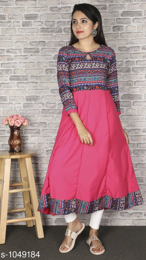 The image displays a woman wearing a bright magenta printed crepe anarkali kurti, which features a flared skirt