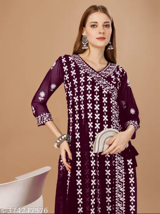 Black and white patterned sleeveless kameez outfit, embroidered borders, handbag in frame