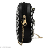 Black ladies crossbody sling purse with a gold chain strap