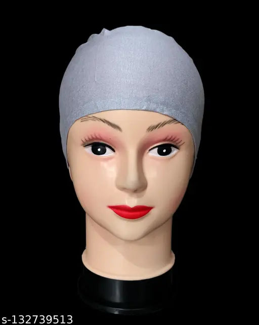 A package with five cotton head wraps, showcasing one cap under a white scarf