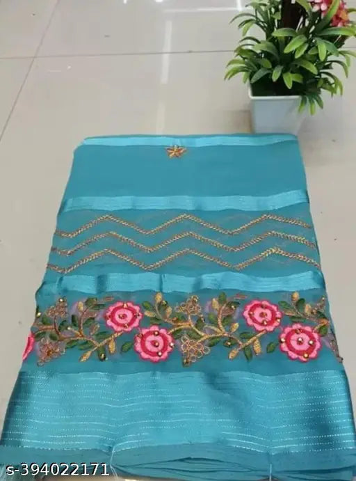 A blue fabric with decorative borders, showcasing intricate embroidery patterns