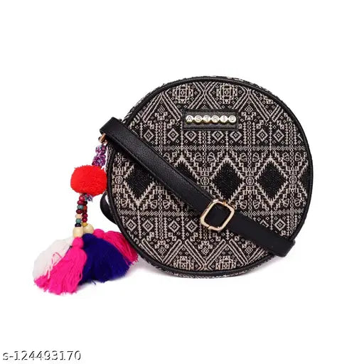 ASTRID round sling bag with pom poms in shades of pink and red, perfect for girls and women