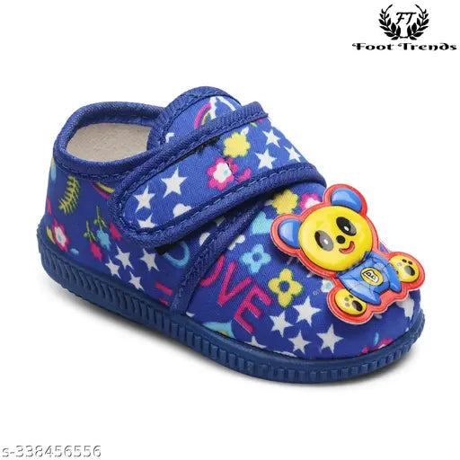 A baby's slipper with a welcro closure, adorned with cartoon characters