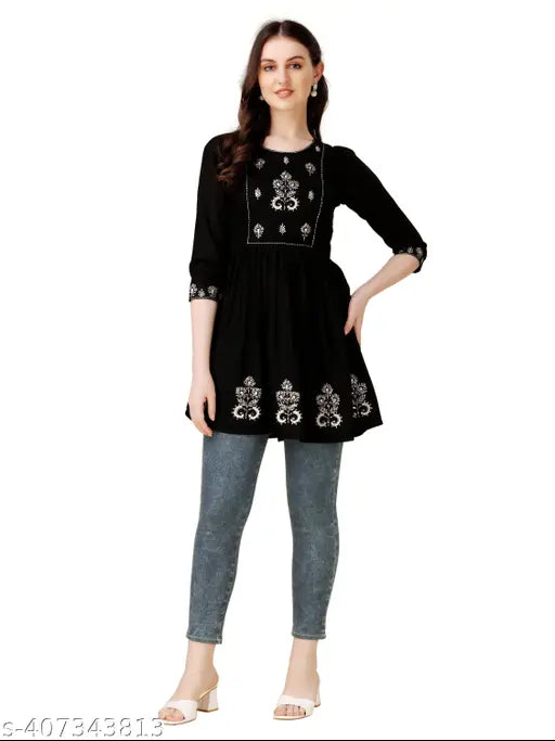 Embroidered rayon A-line tunic for women, three-quarter sleeves, vibrant pattern on display