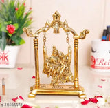 Gold metal Krishna idol playing flute on jhula decorative showpiece, traditional handicraft with antique finish, 20cm long and 17.5cm high, ideal for worship and home decoration
