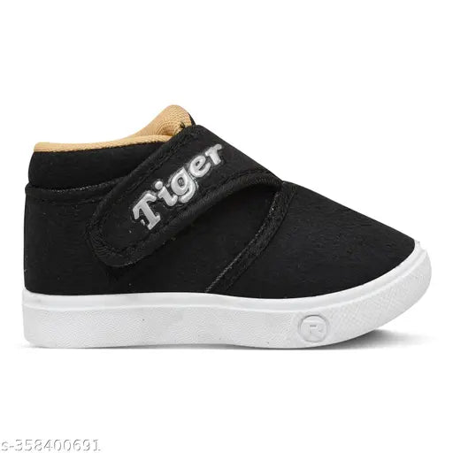 Black velvet slip-ons with "Tiger" written on the side for kids