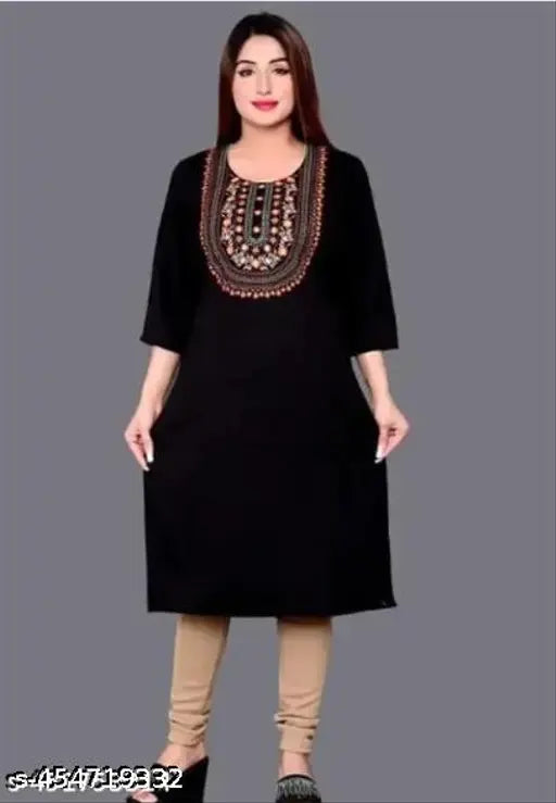 A woman wearing a long, dark blue, straight-cut kameez with visible zipper detail