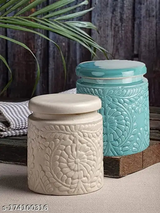 A cream and off-white ceramic jar with a lid, likely for cooking or baking storage