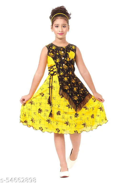 A child wearing a stylish yellow and black cotton frock with a V-neckline, standing