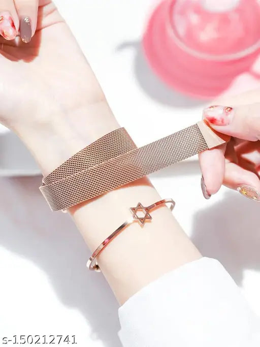 Two-tone black and rose gold analogue watch featuring a delicate design with a heart shape in the center and a butterfly on one side, paired with a matching bracelet