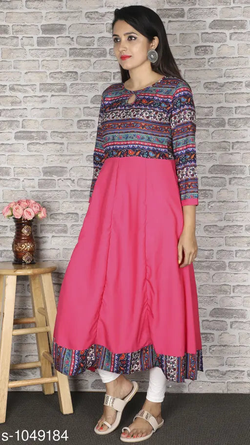 A woman wearing a long, magenta printed anarkali kurta with a crew neck