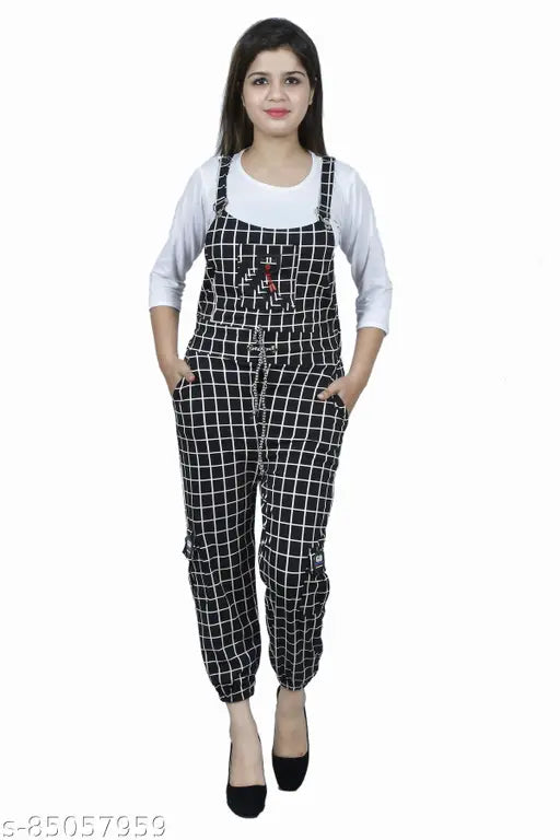 Black cotton blend dungaree dress with adjustable shoulder straps, three-quarter sleeves, multi-colored check pattern. Perfect for casual weekend outings, Made in India with stainless steel lock