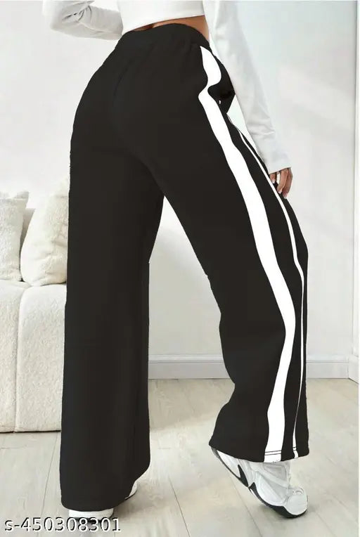 The image displays a pair of women's funky, casual bell-bottom trousers. The pants feature wide legs and are designed in a black and white striped pattern