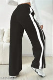 The image displays a pair of women's funky, casual bell-bottom trousers. The pants feature wide legs and are designed in a black and white striped pattern