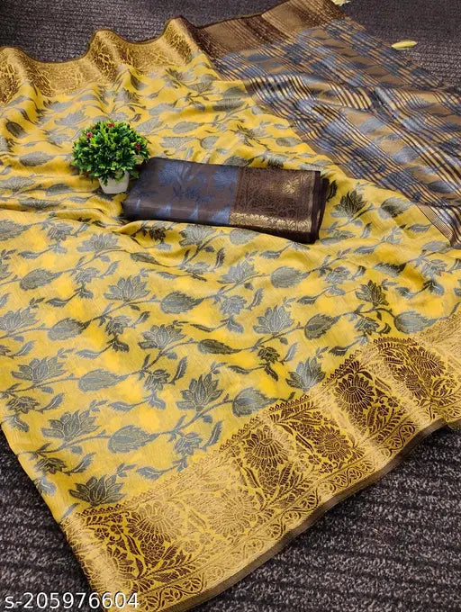 Yellow and green patterned silk saree with copper zari detailing, presented on a fabric stand