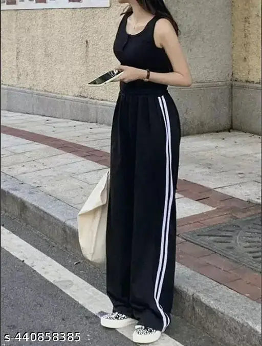 Black cropped track pants with white stripes