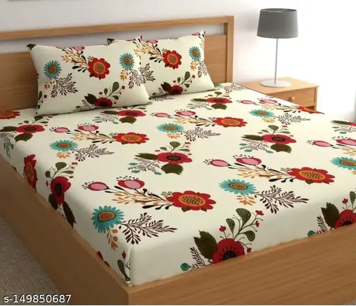 Flowered comforter set with pillow covers on a bed, displayed as part of a sale
