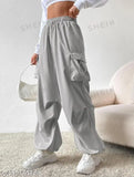 Grey track pants with cargo pockets, white graphic tee