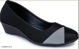 Black synthetic ballerinas for women, closed back design on display stand