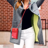 A person stands against a brick building, smiling; she wears a grey coat, white pants, and a red purse. The image prominently features a stylish handbag with various compartments, likely for essentials such as a cell phone and a wallet